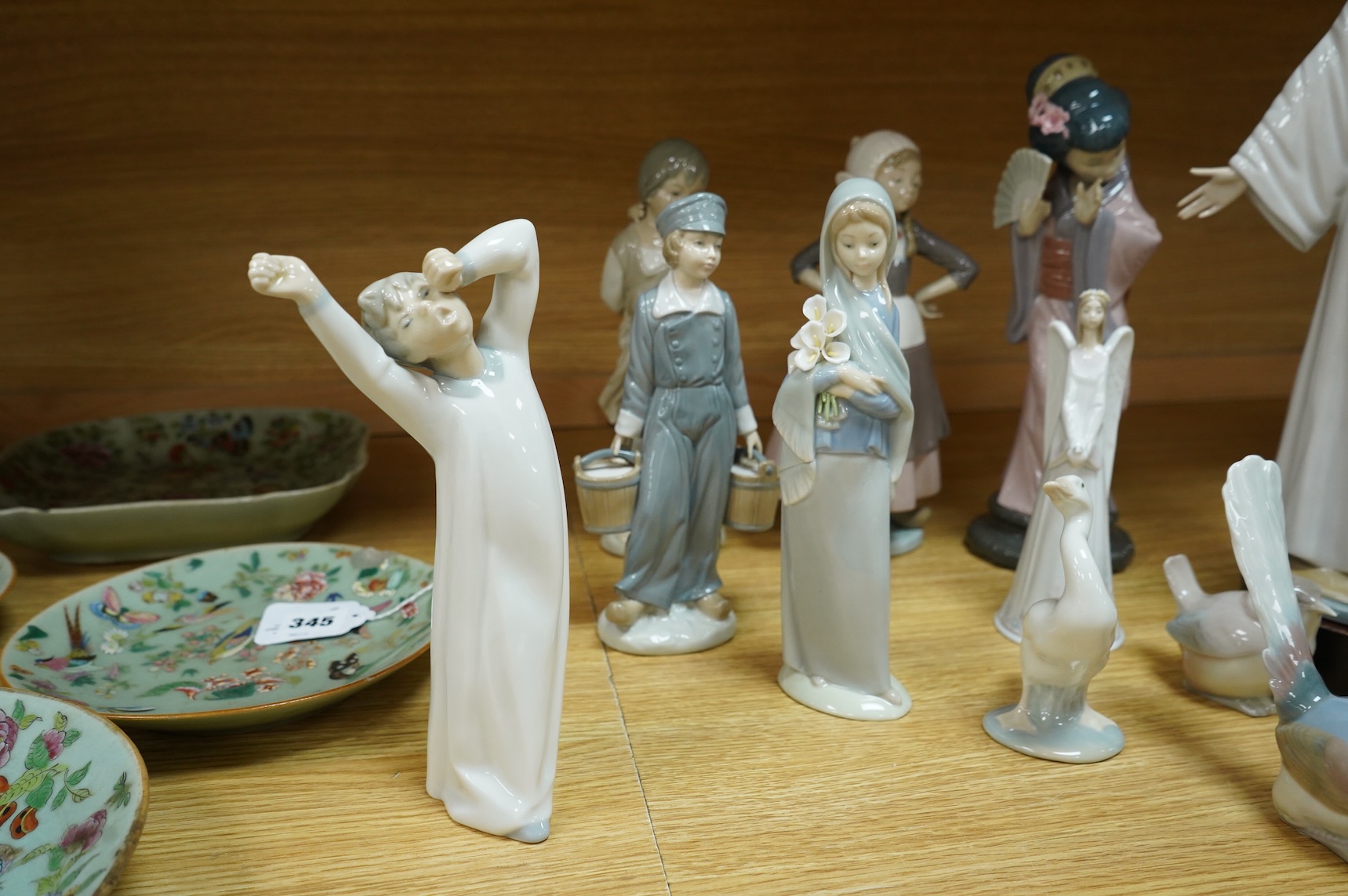 A group of Lladro figurines including: a Japanese Geisha, a model of Christ, 3 birds, various children, an angel bell etc. (all boxed) (13)